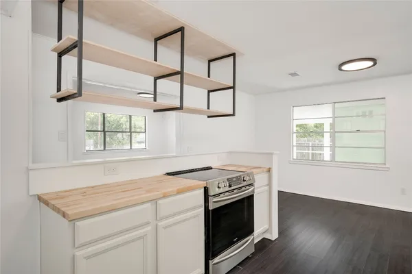a kitchen with stainless steel appliances granite countertop a stove and a sink