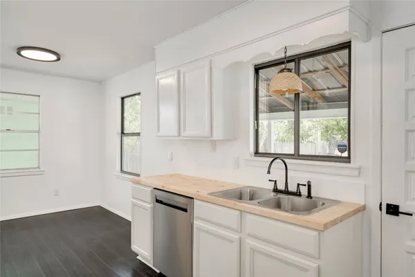 a kitchen with a sink cabinets and a window