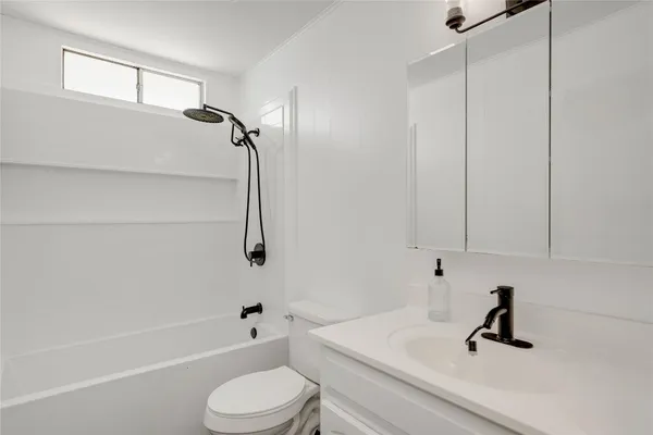 a bathroom with a sink a toilet and a bathtub