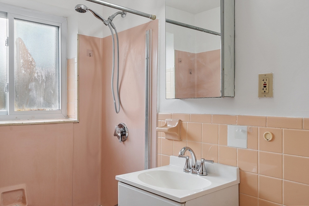 26 Bryon Road, Unit 3 Boston, MA 02467 - Photo 17 of 30 a bathroom with a shower a sink and a mirror