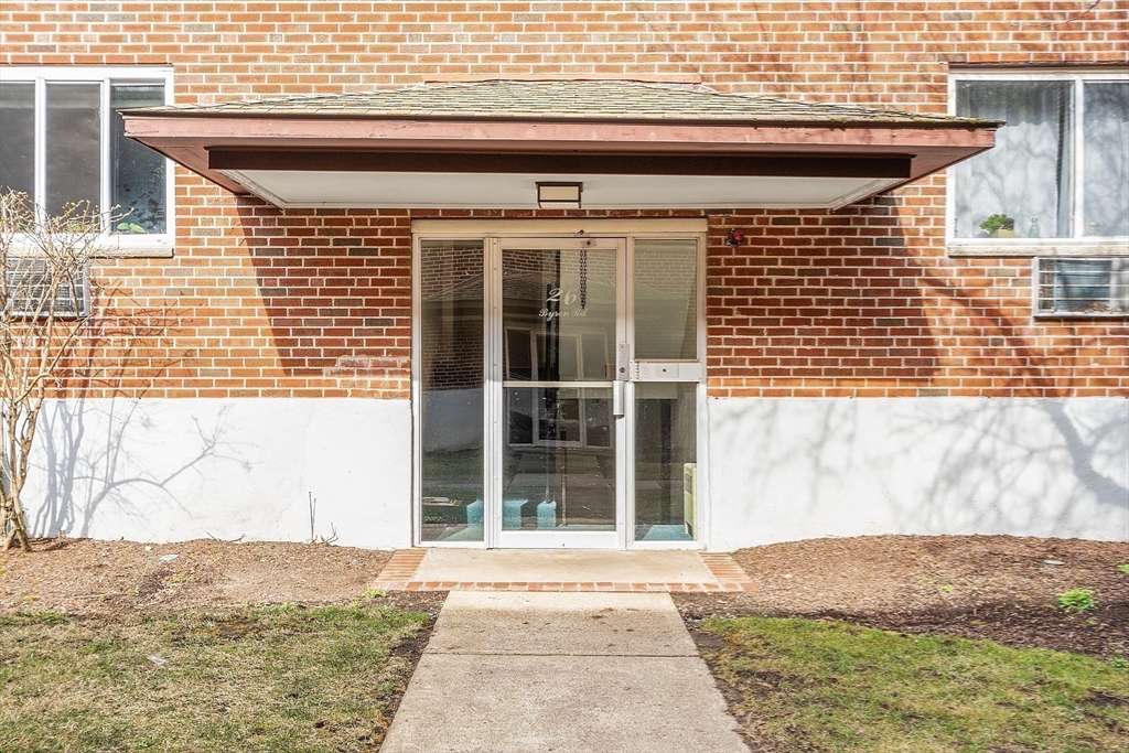 26 Bryon Road, Unit 3 Boston, MA 02467 - Photo 19 of 30 a front view of a house with a yard
