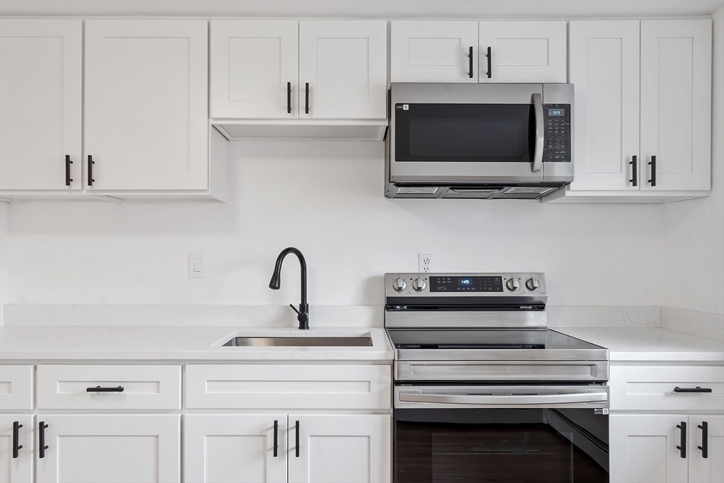 26 Bryon Road, Unit 3 Boston, MA 02467 - Photo 2 of 30 a kitchen with a stove and a microwave