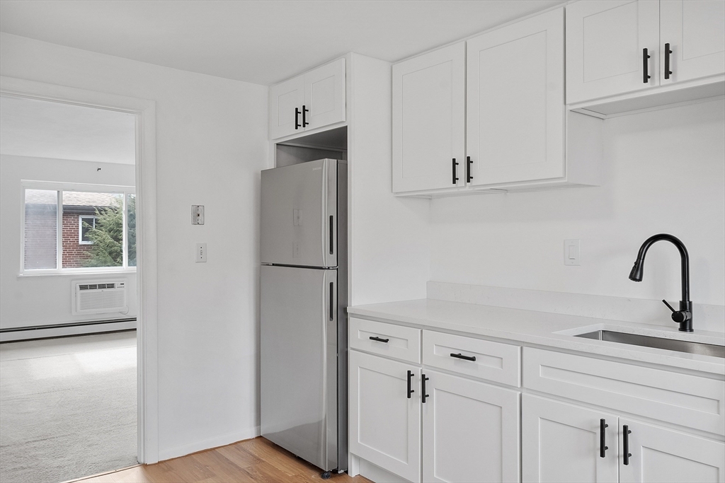 26 Bryon Road, Unit 3 Boston, MA 02467 - Photo 7 of 30 a kitchen with a refrigerator and cabinets