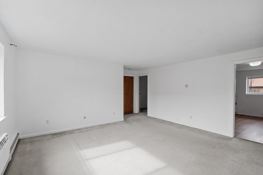 26 Bryon Road, Unit 3 Boston, MA 02467 - Photo 8 of 30 an empty room with windows