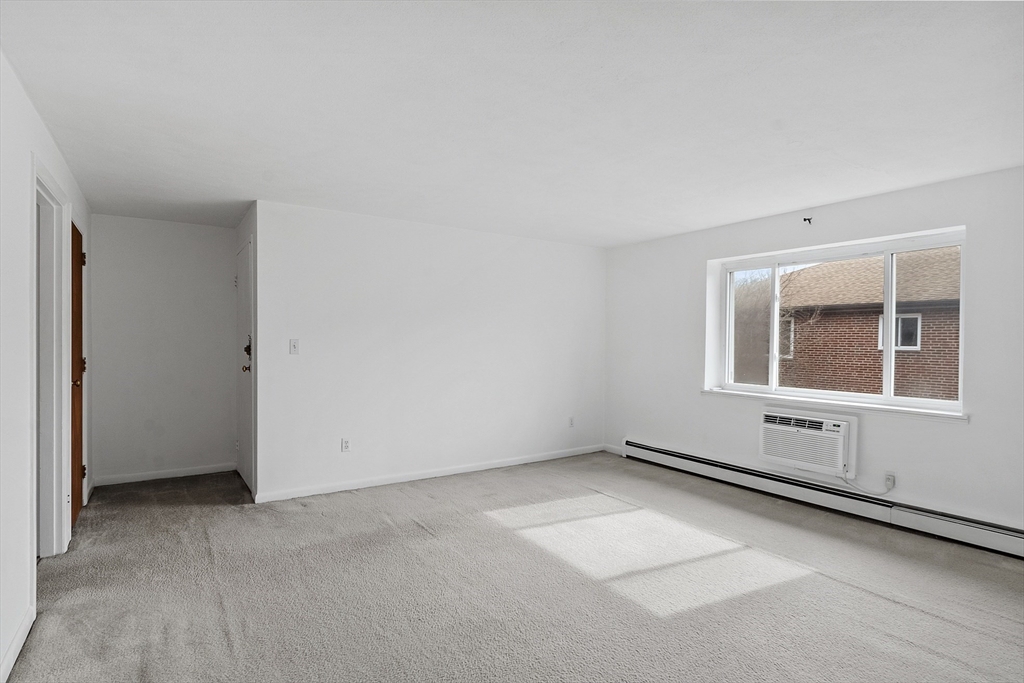 26 Bryon Road, Unit 3 Boston, MA 02467 - Photo 10 of 30 an empty room with windows