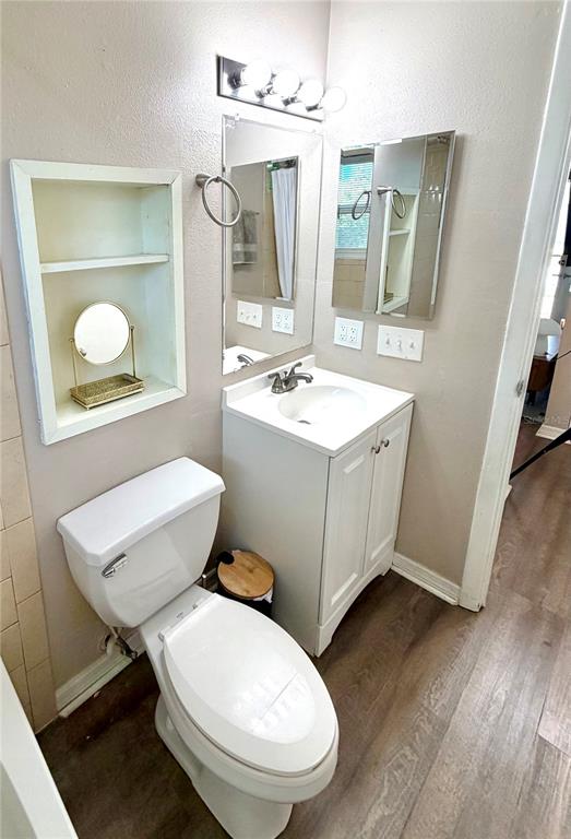 7974 Avenal Loop New Port Richey, FL 34655 - Photo 13 of 23 a bathroom with a toilet a sink and mirror