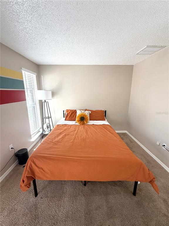7974 Avenal Loop New Port Richey, FL 34655 - Photo 16 of 23 a bedroom with a bed and a window