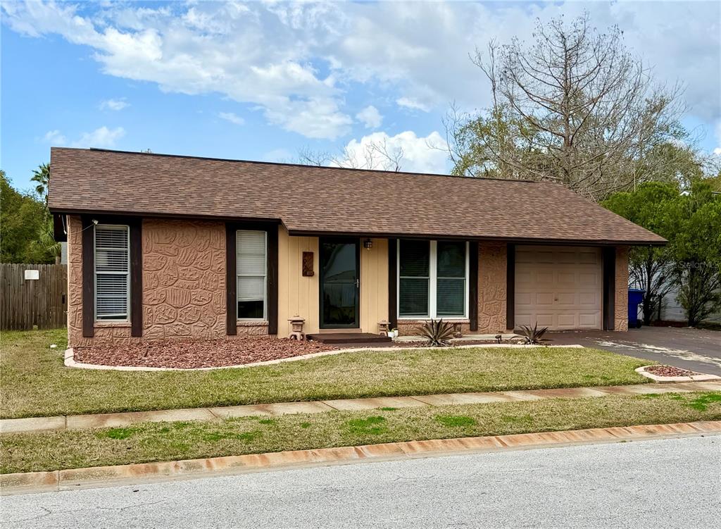 7974 Avenal Loop New Port Richey, FL 34655 - Photo 2 of 23 a front view of a house with a yard