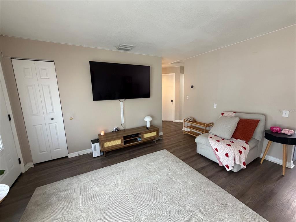 7974 Avenal Loop New Port Richey, FL 34655 - Photo 4 of 23 a bedroom with furniture and a flat screen tv