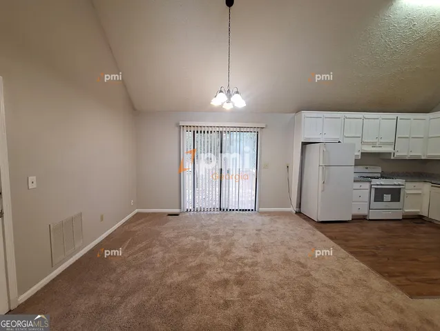 a view of a kitchen with a sink stove and refrigerator