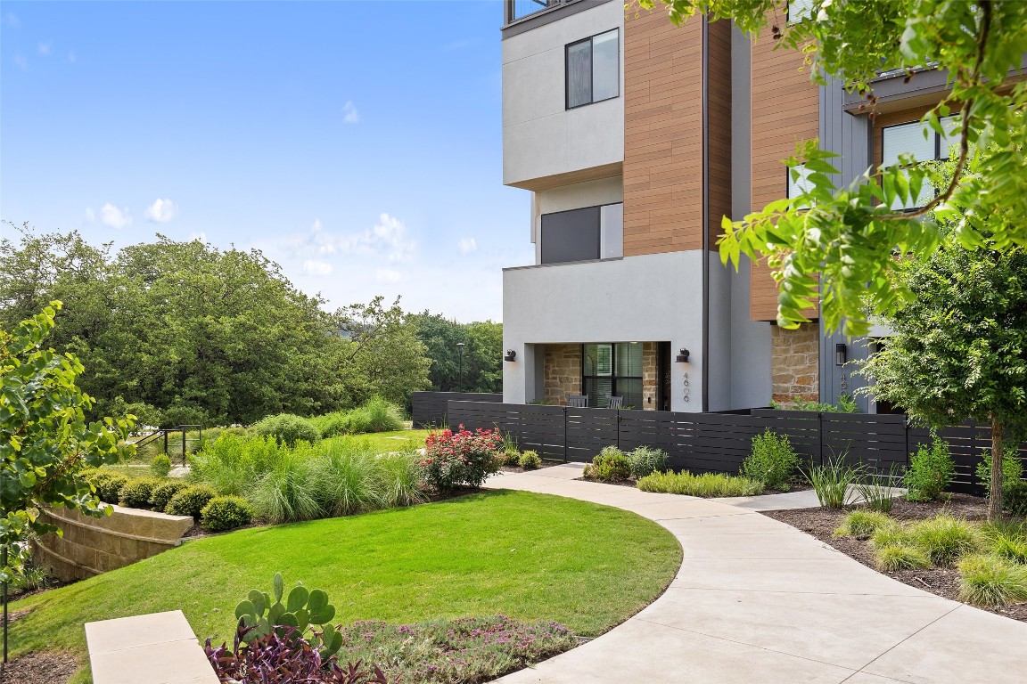 a front view of a house with a garden and plants