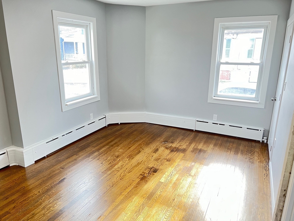 211 Jefferson Street Fall River, MA 02721 - Photo 12 of 17 a view of empty room with wooden floor and fan