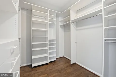 an empty room with a refrigerator and windows
