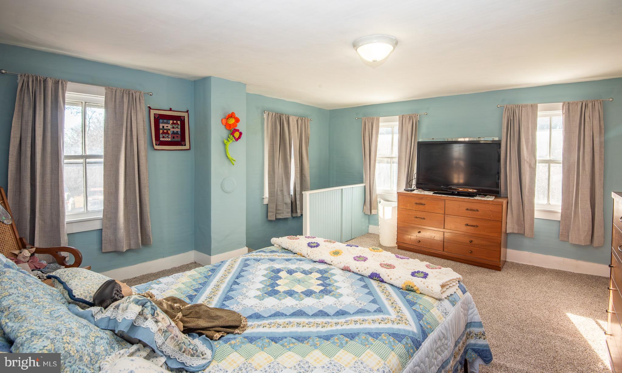 14735 Montresor Road Leesburg, VA 20176 - Photo 20 of 46 a bedroom with a bed and a flat screen tv