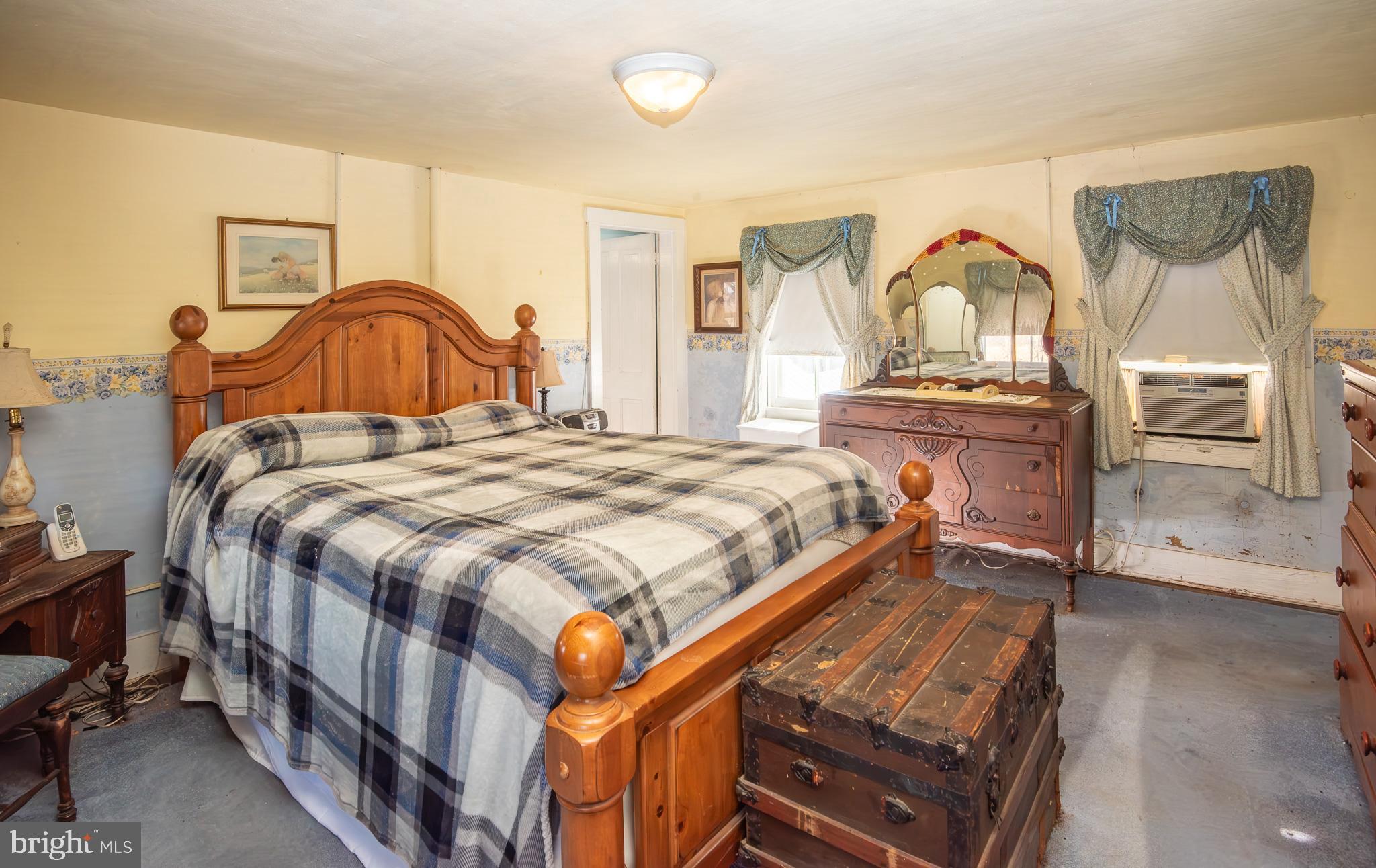 14735 Montresor Road Leesburg, VA 20176 - Photo 22 of 46 a bedroom with a bed a mirror and dresser