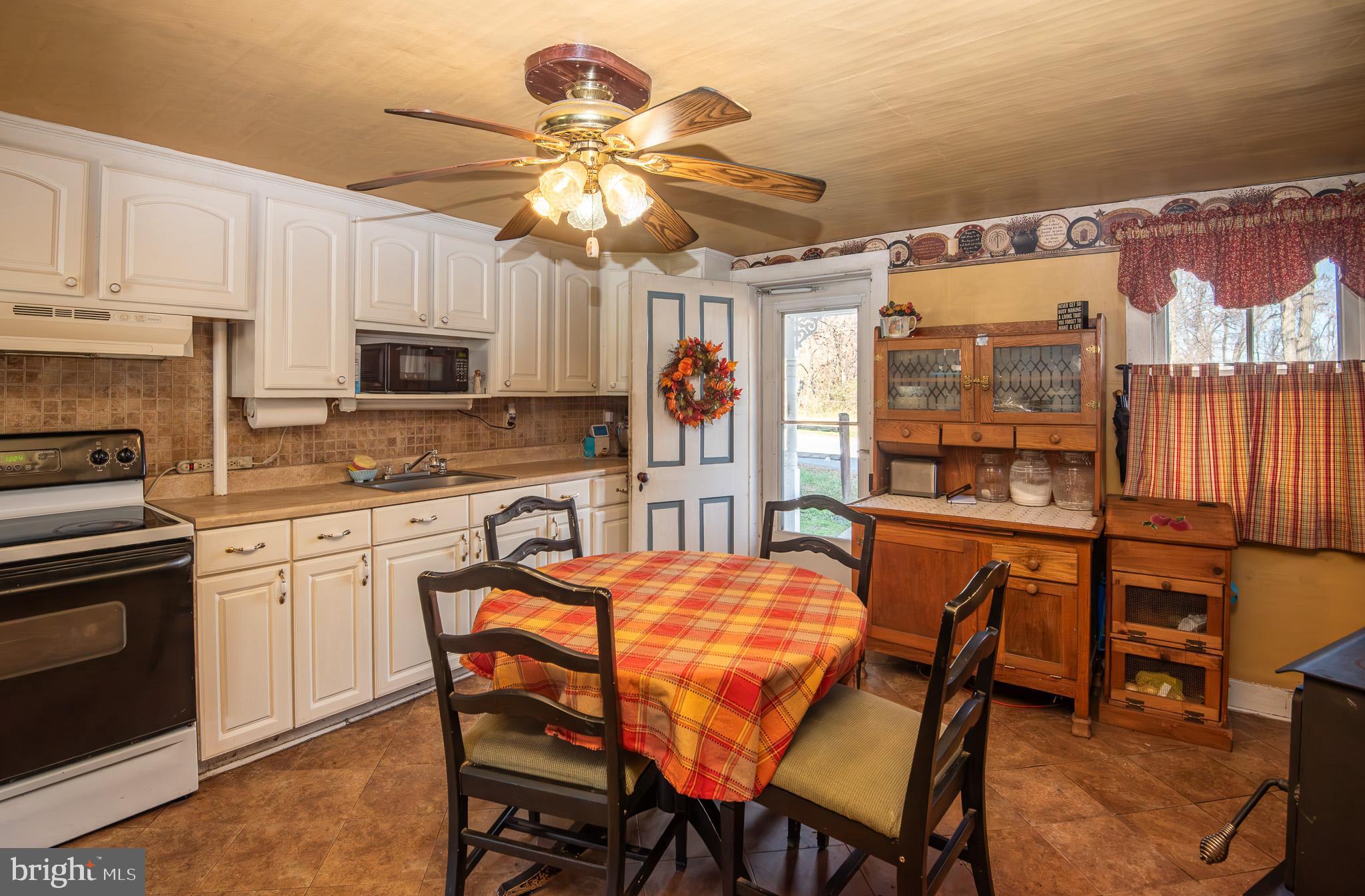 14735 Montresor Road Leesburg, VA 20176 - Photo 30 of 46 a kitchen with stainless steel appliances granite countertop a stove top oven a sink dishwasher and a refrigerator with wooden floor