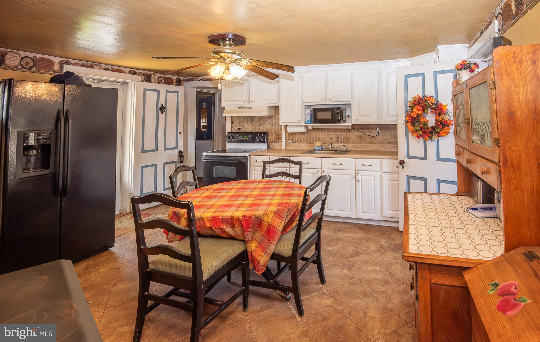 14735 Montresor Road Leesburg, VA 20176 - Photo 31 of 46 a kitchen with stainless steel appliances kitchen island granite countertop a refrigerator and microwave
