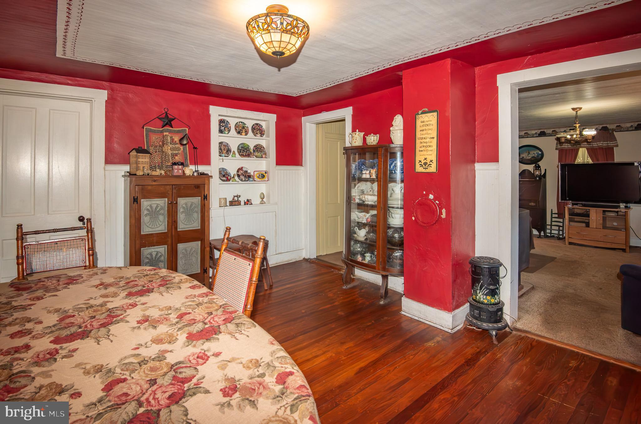 14735 Montresor Road Leesburg, VA 20176 - Photo 32 of 46 a bedroom with a bed and a chandelier