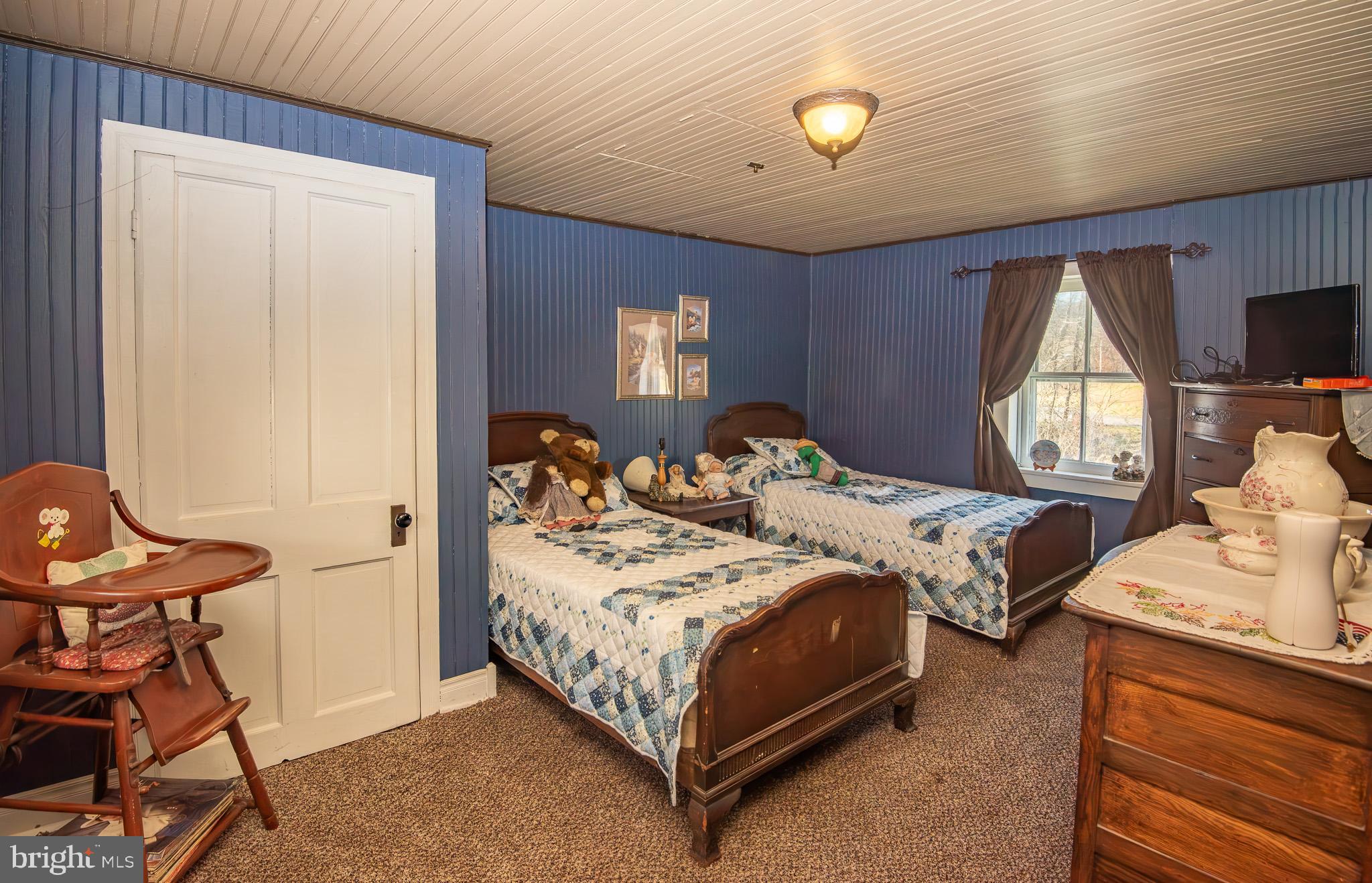 14735 Montresor Road Leesburg, VA 20176 - Photo 8 of 46 a bedroom with a bed and a chandelier