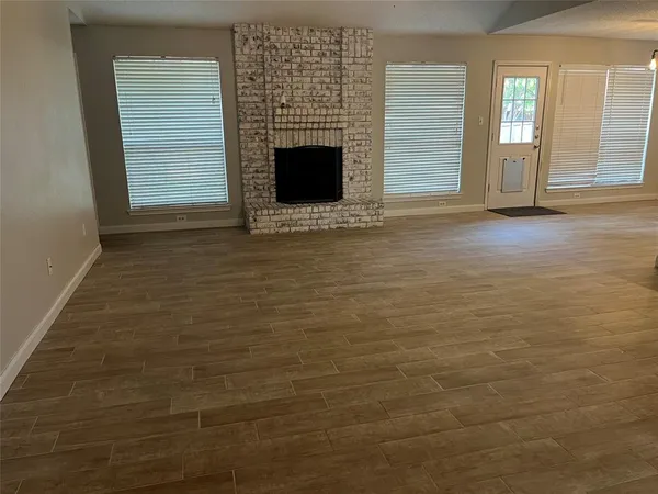 a view of a livingroom with an empty space and a fireplace
