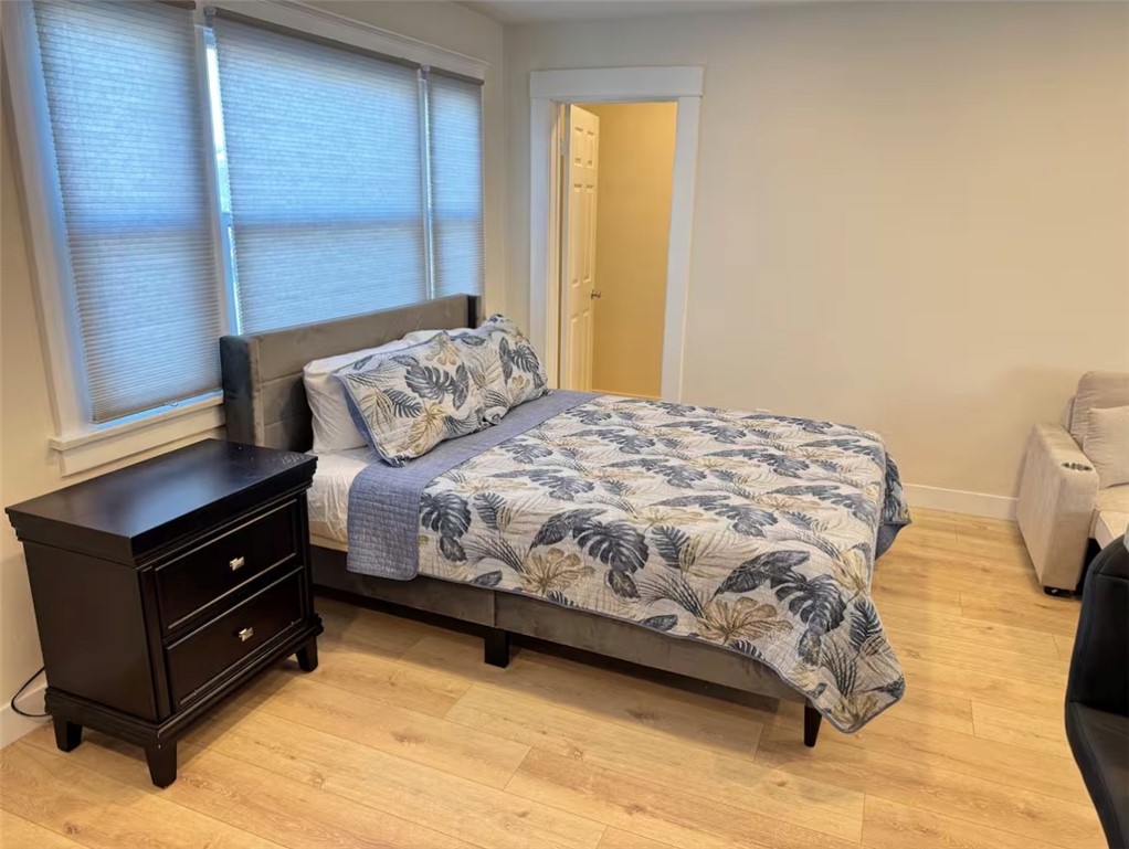 123 6th Street Huntington Beach, CA 92648 - Photo 2 of 7 a bedroom with a bed dresser and a window