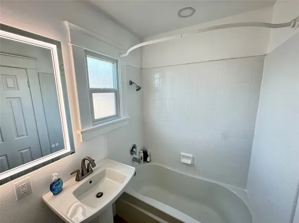 a bathroom with a sink and shower