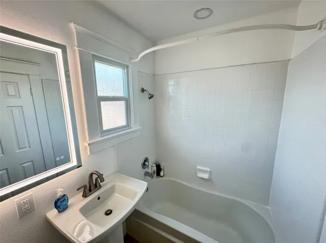 a bathroom with a sink and shower