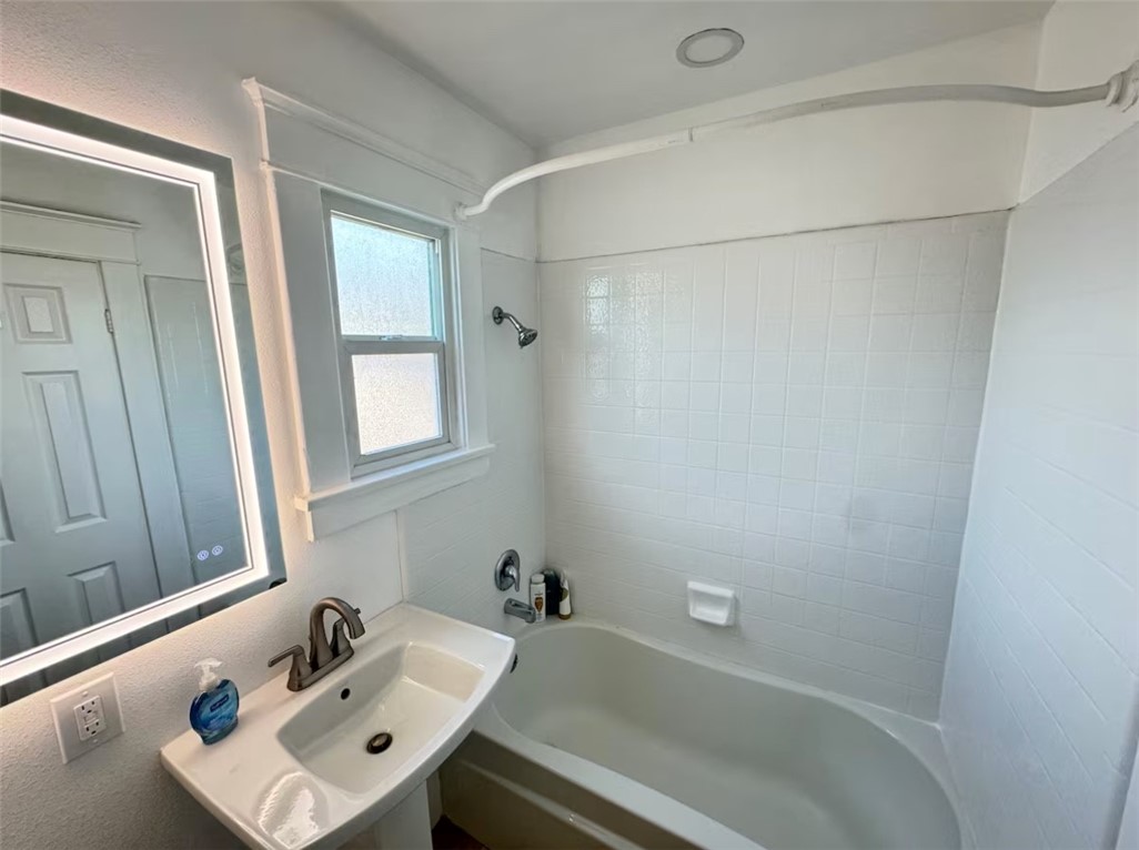 123 6th Street Huntington Beach, CA 92648 - Photo 4 of 7 a bathroom with a sink and shower