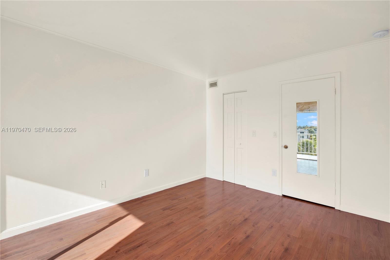 7747 Southwest 86th Street, Unit D403 Miami, FL 33143 - Photo 12 of 25 a view of an empty room with wooden floor