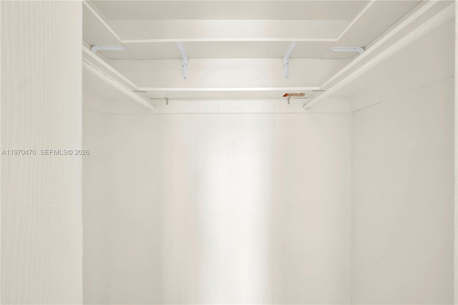 7747 Southwest 86th Street, Unit D403 Miami, FL 33143 - Photo 14 of 25 a view of an empty walk in closet