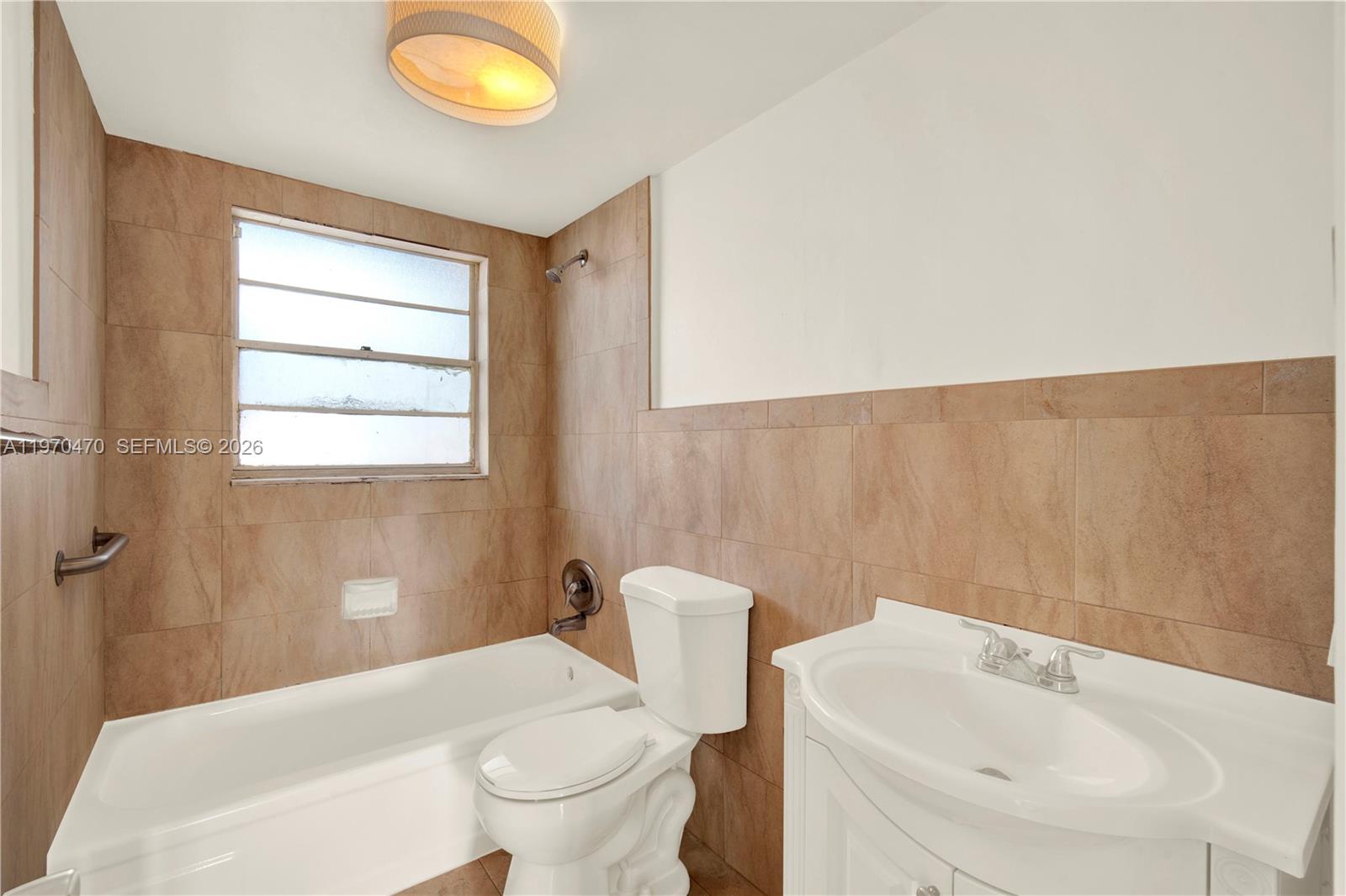 7747 Southwest 86th Street, Unit D403 Miami, FL 33143 - Photo 15 of 25 a bathroom with a sink and a mirror