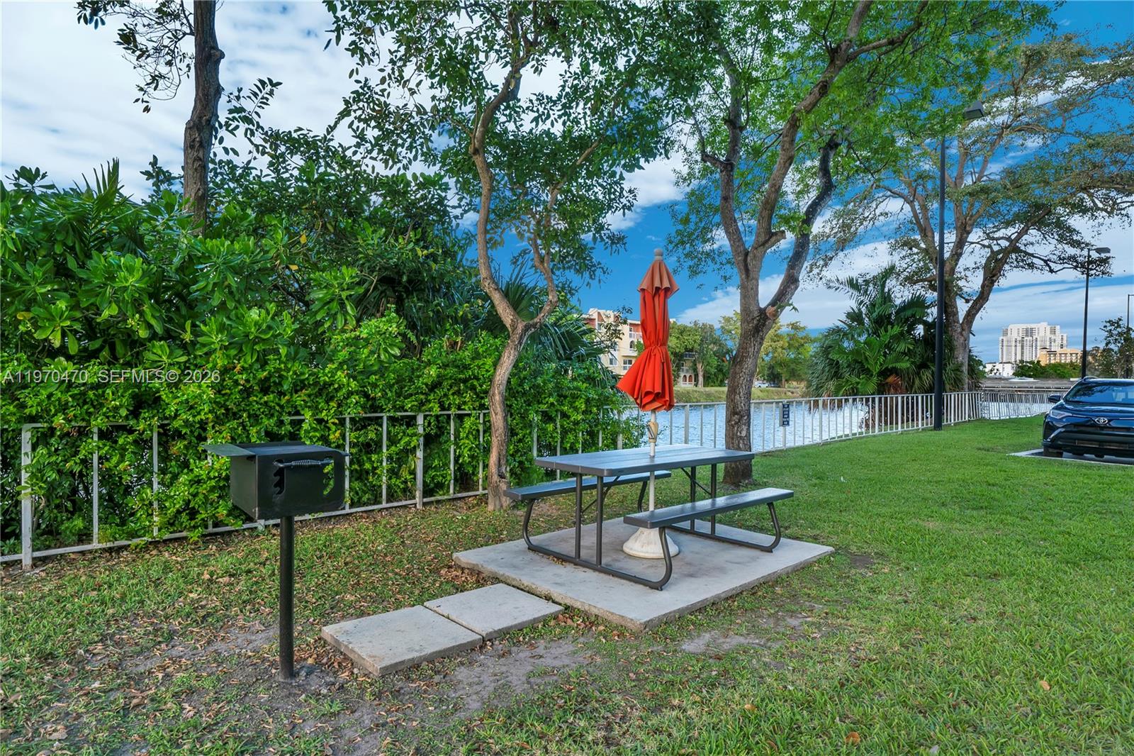 7747 Southwest 86th Street, Unit D403 Miami, FL 33143 - Photo 22 of 25 a park view with a bench and trees