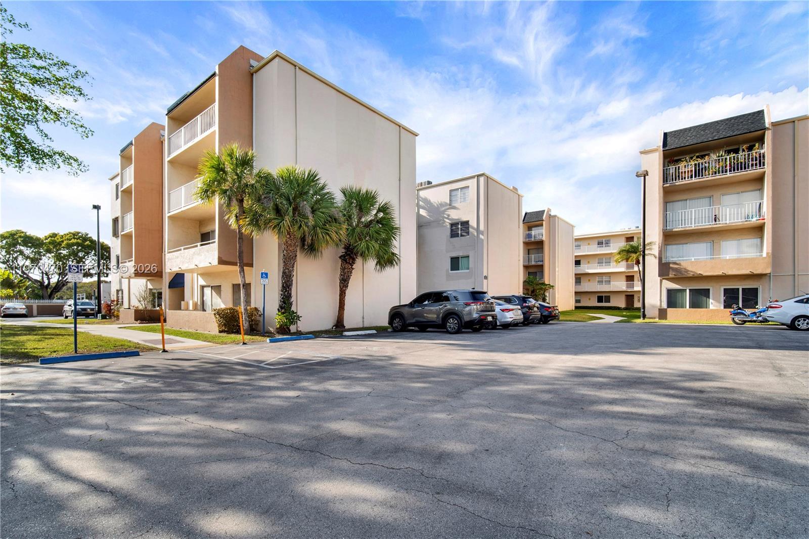 7747 Southwest 86th Street, Unit D403 Miami, FL 33143 - Photo 3 of 25 a view of a tall building next to a road