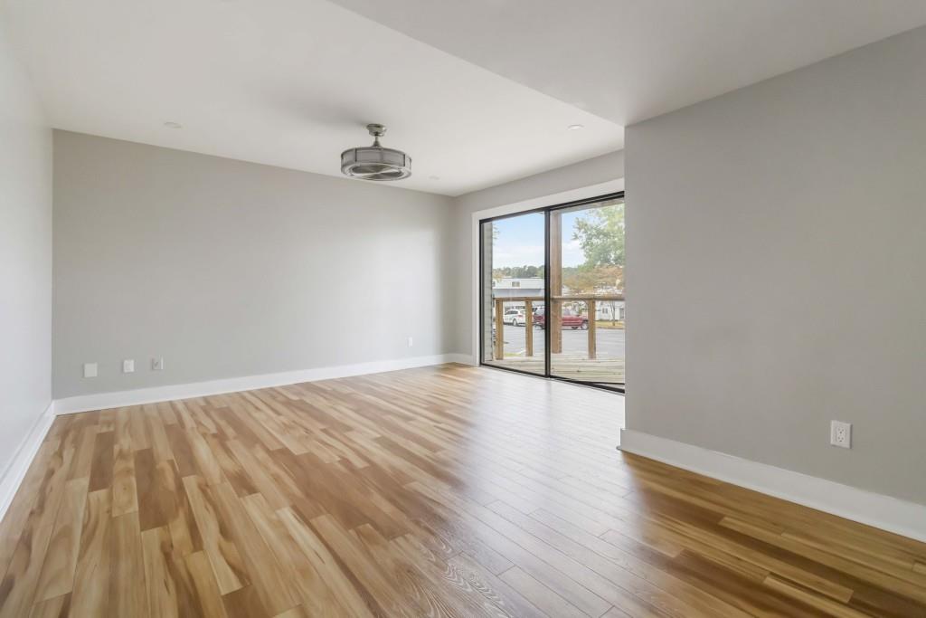 266 Clearview Court, Unit 266 Villa Rica, GA 30180 - Photo 18 of 32 wooden floor in an empty room with a window