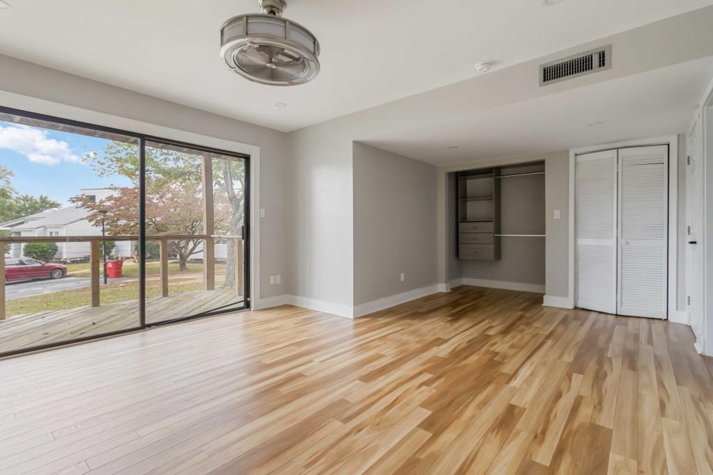 266 Clearview Court, Unit 266 Villa Rica, GA 30180 - Photo 19 of 32 an empty room with wooden floor and windows