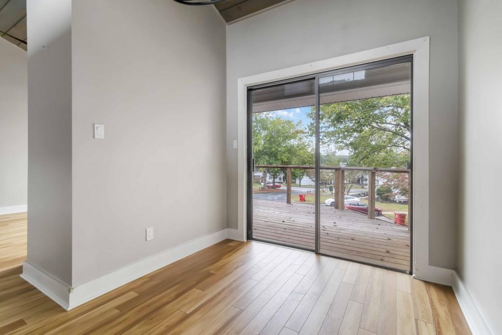 266 Clearview Court, Unit 266 Villa Rica, GA 30180 - Photo 22 of 32 a view of a room with wooden floor and balcony