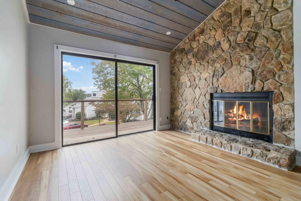 266 Clearview Court, Unit 266 Villa Rica, GA 30180 - Photo 5 of 32 a view of an empty room with wooden floor and a fireplace