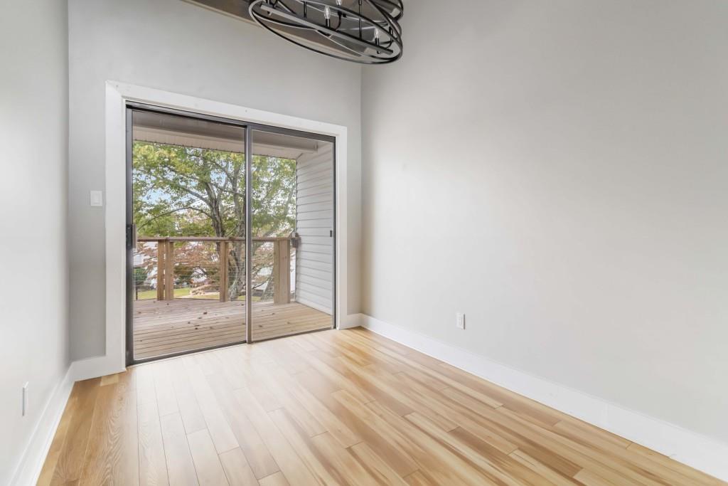 266 Clearview Court, Unit 266 Villa Rica, GA 30180 - Photo 7 of 32 an empty room with wooden floor and windows