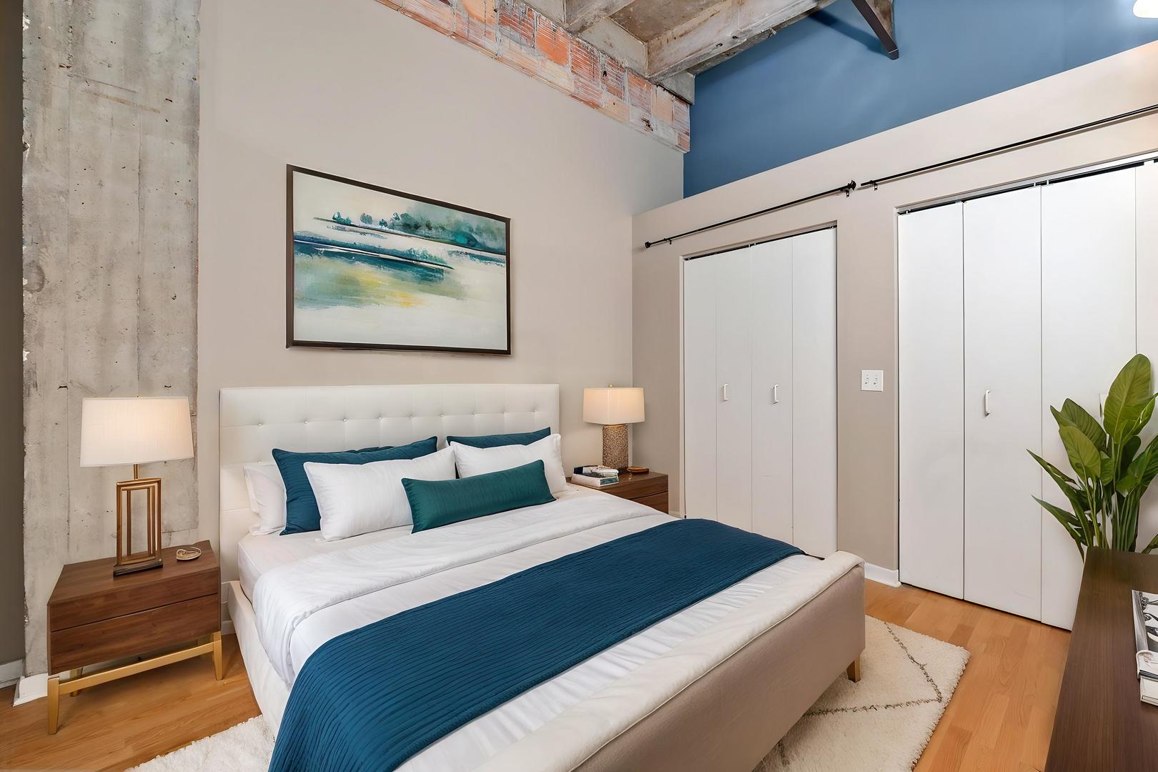 20 North State Street, Unit 611 Chicago, IL 60602 - Photo 12 of 17 a bedroom with a bed and a potted plant