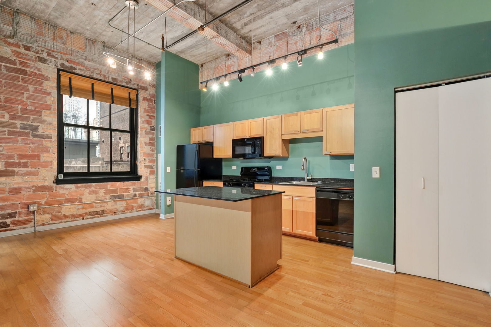 20 North State Street, Unit 611 Chicago, IL 60602 - Photo 8 of 17 a kitchen with stainless steel appliances granite countertop a stove a sink and a refrigerator