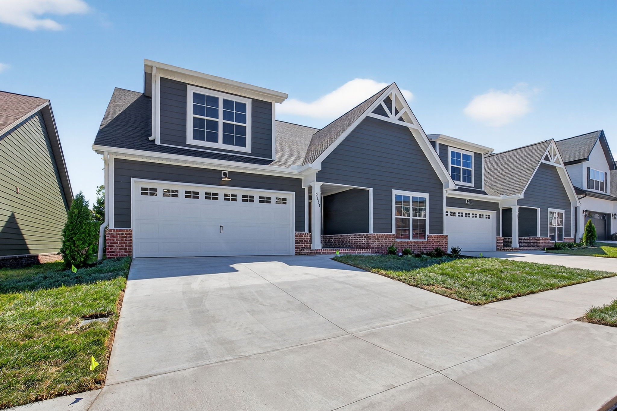 2111 Rylee Way, Unit 9 Greenbrier, TN 37073 - Photo 2 of 33 a front view of a house with a yard and garage