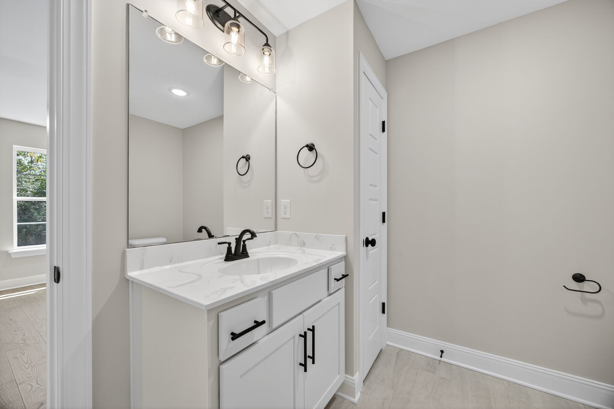 2111 Rylee Way, Unit 9 Greenbrier, TN 37073 - Photo 28 of 33 a bathroom with a sink a mirror and a vanity