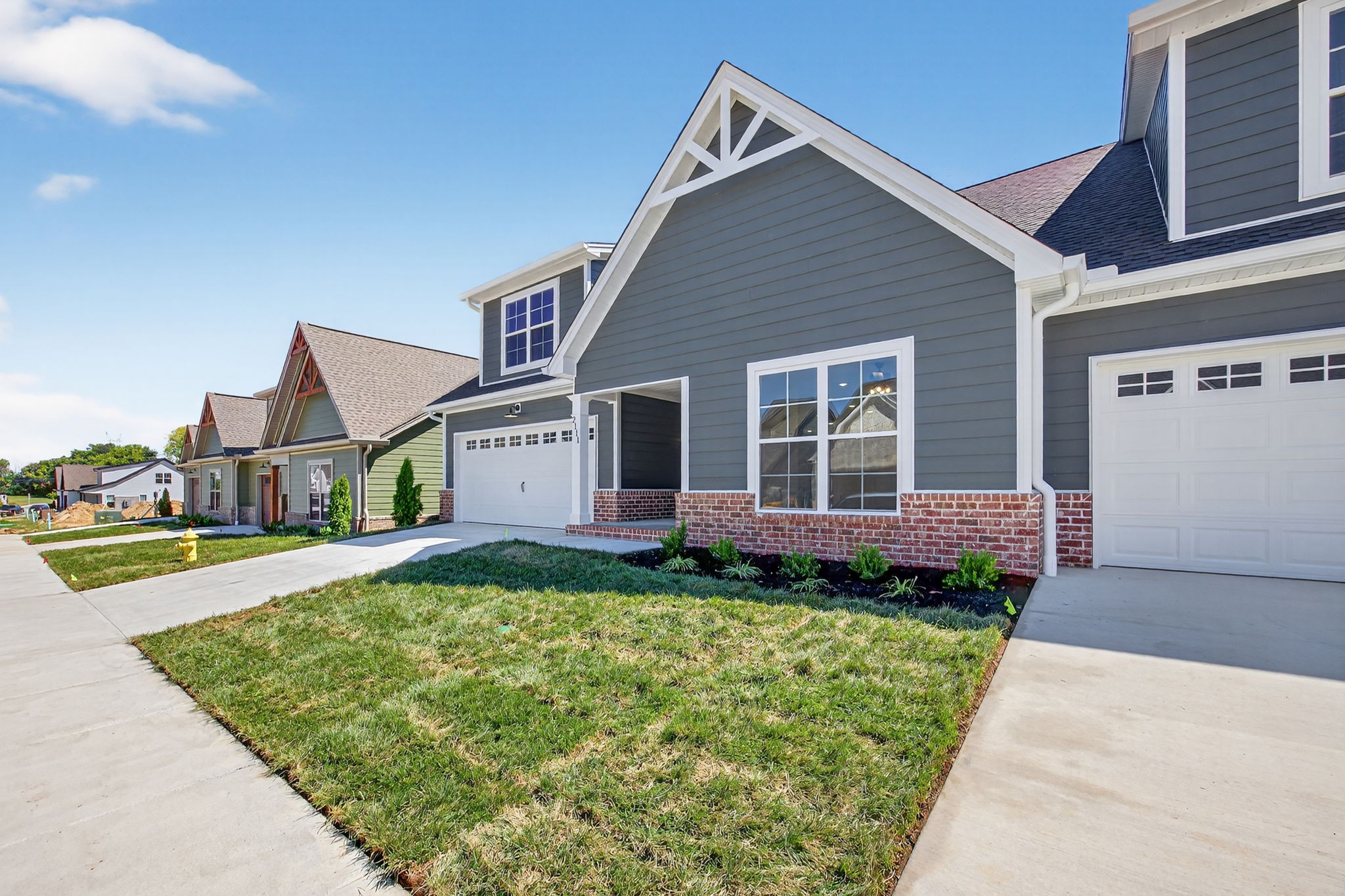 2111 Rylee Way, Unit 9 Greenbrier, TN 37073 - Photo 3 of 33 a view of a house with a big yard plants and large trees