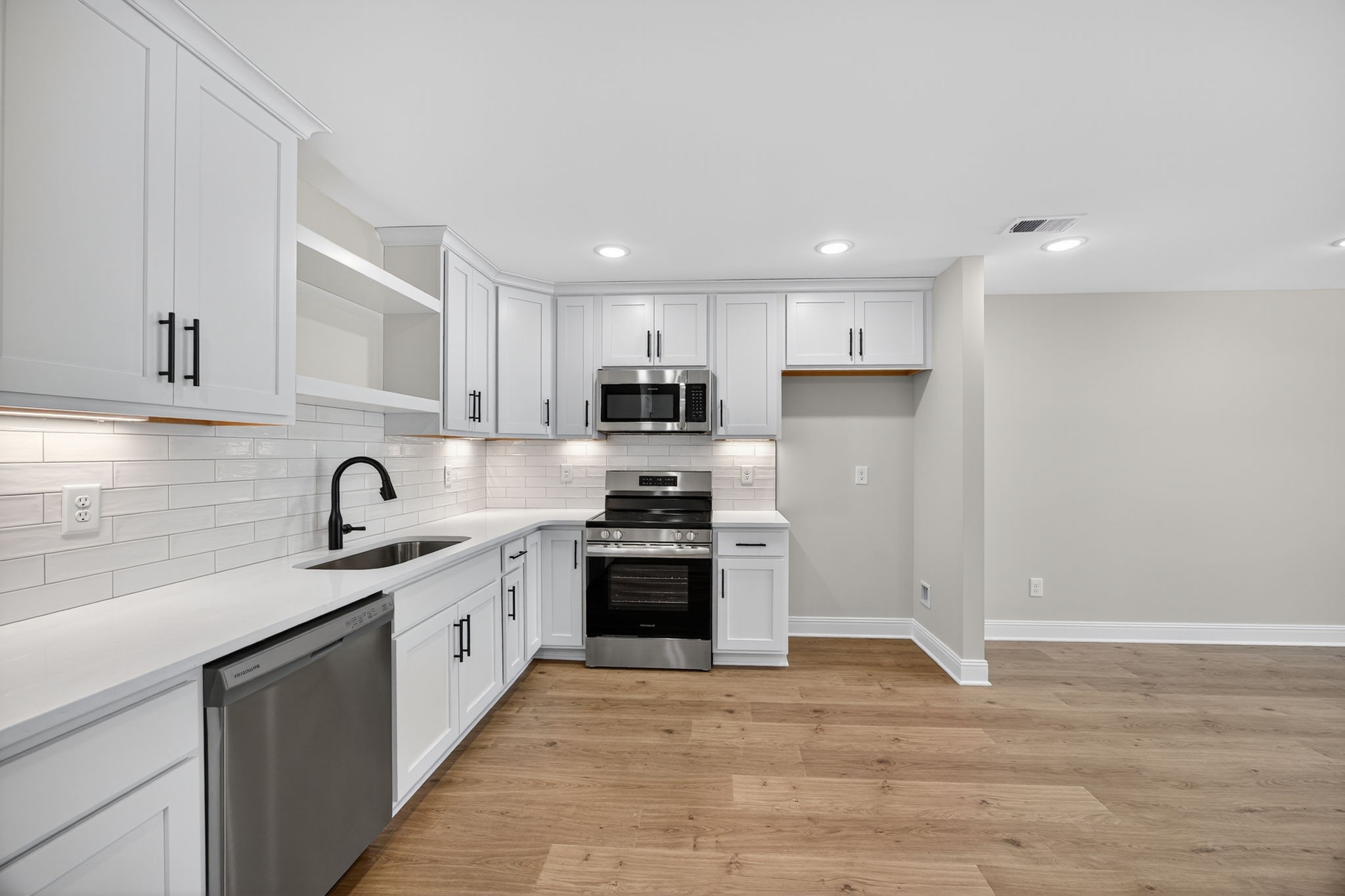2111 Rylee Way, Unit 9 Greenbrier, TN 37073 - Photo 10 of 33 a large kitchen with granite countertop a stove top oven a sink dishwasher and a refrigerator with wooden cabinets