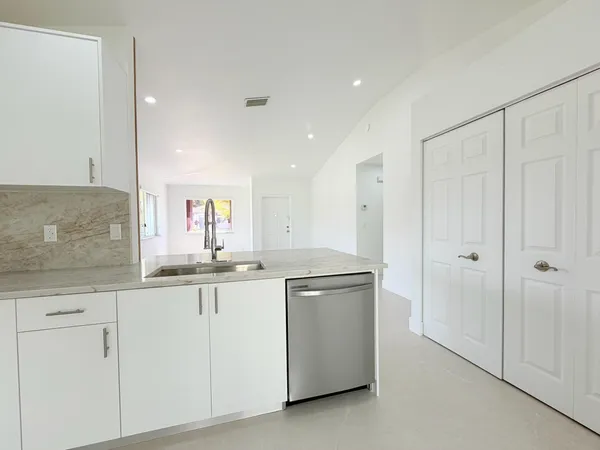 a kitchen with white cabinets