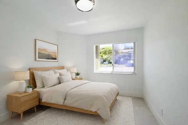a bedroom with a bed and a painting on the wall