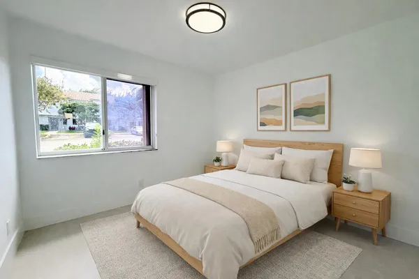 a bedroom with a bed and a window