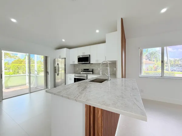 a kitchen with stainless steel appliances a microwave a stove and refrigerator