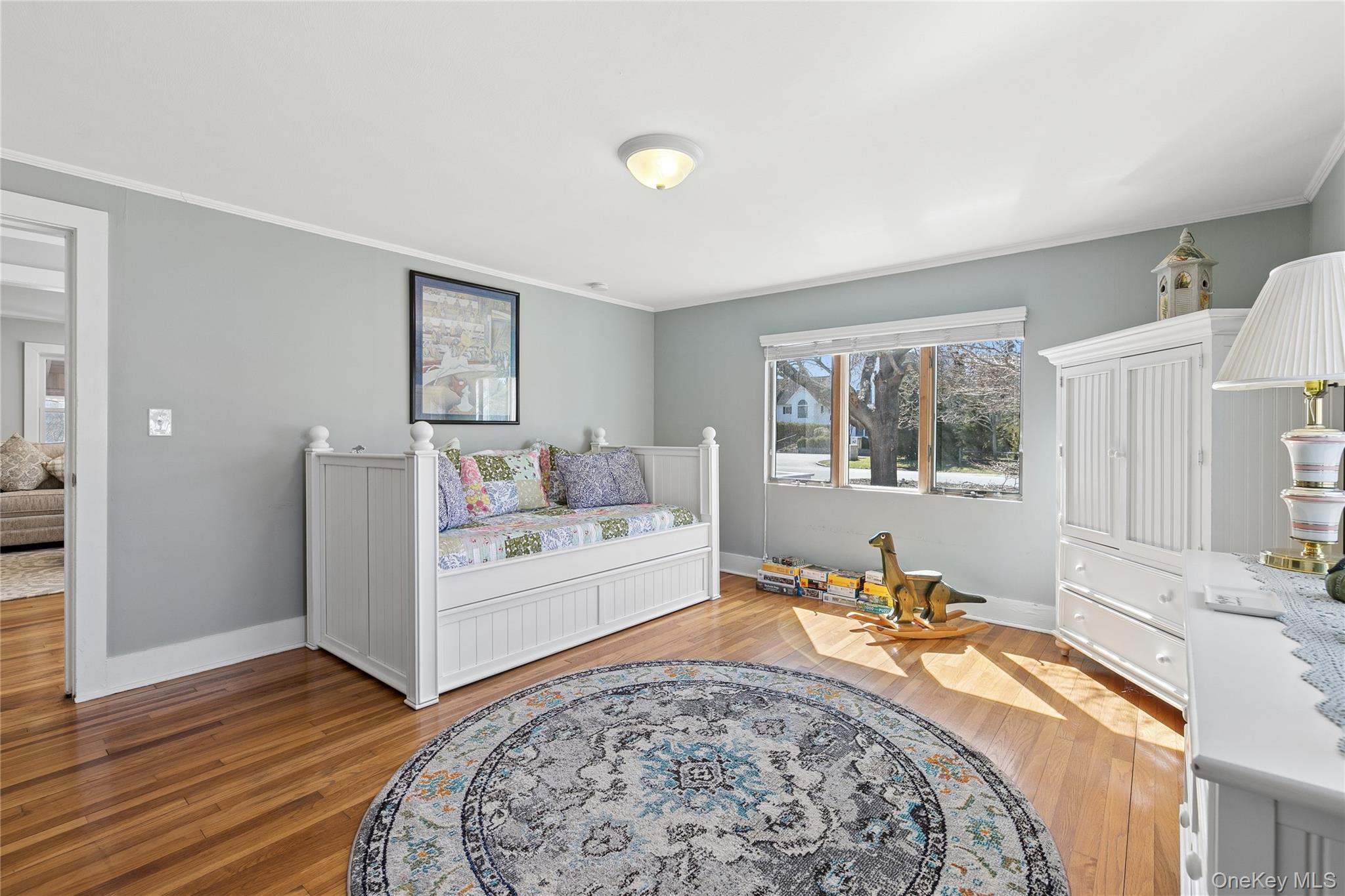 20 Mitchell Road Westhampton Beach, NY 11978 - Photo 11 of 34 a view of a bedroom with wooden floor and a window