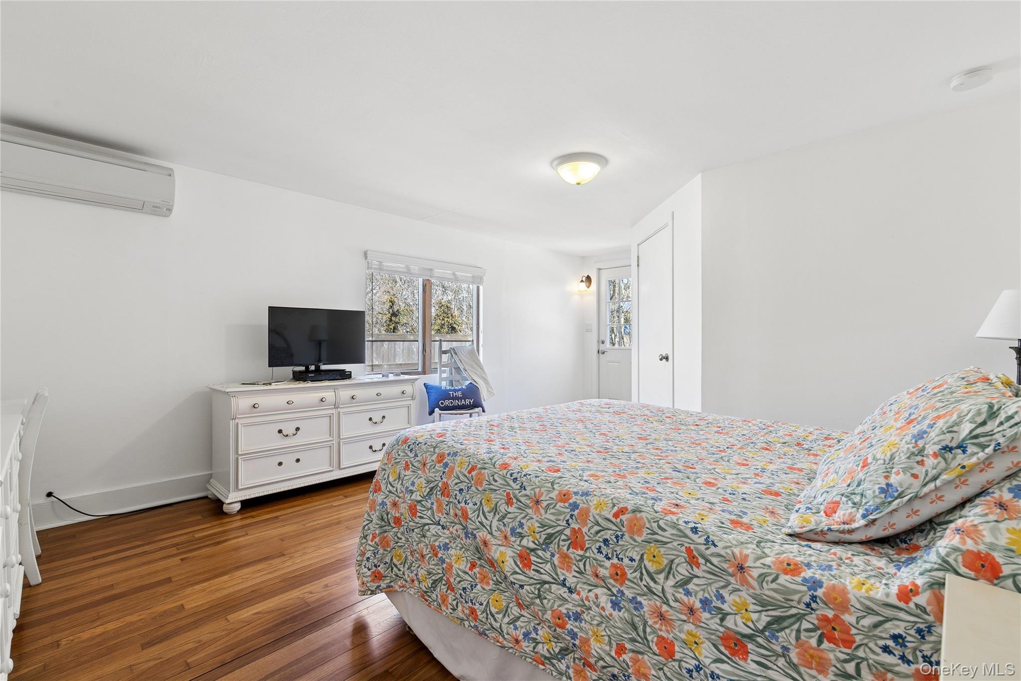 20 Mitchell Road Westhampton Beach, NY 11978 - Photo 12 of 34 a bedroom with a bed and flat tv